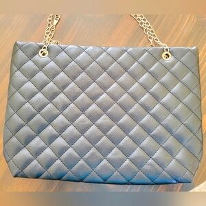 Black purse with gold closure and chain